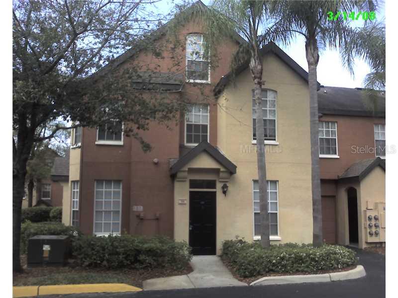 6324 Raleigh Street, Unit 701 Orlando, FL 32835 - Photo 1 of 1 a front view of a house with a yard and potted plants