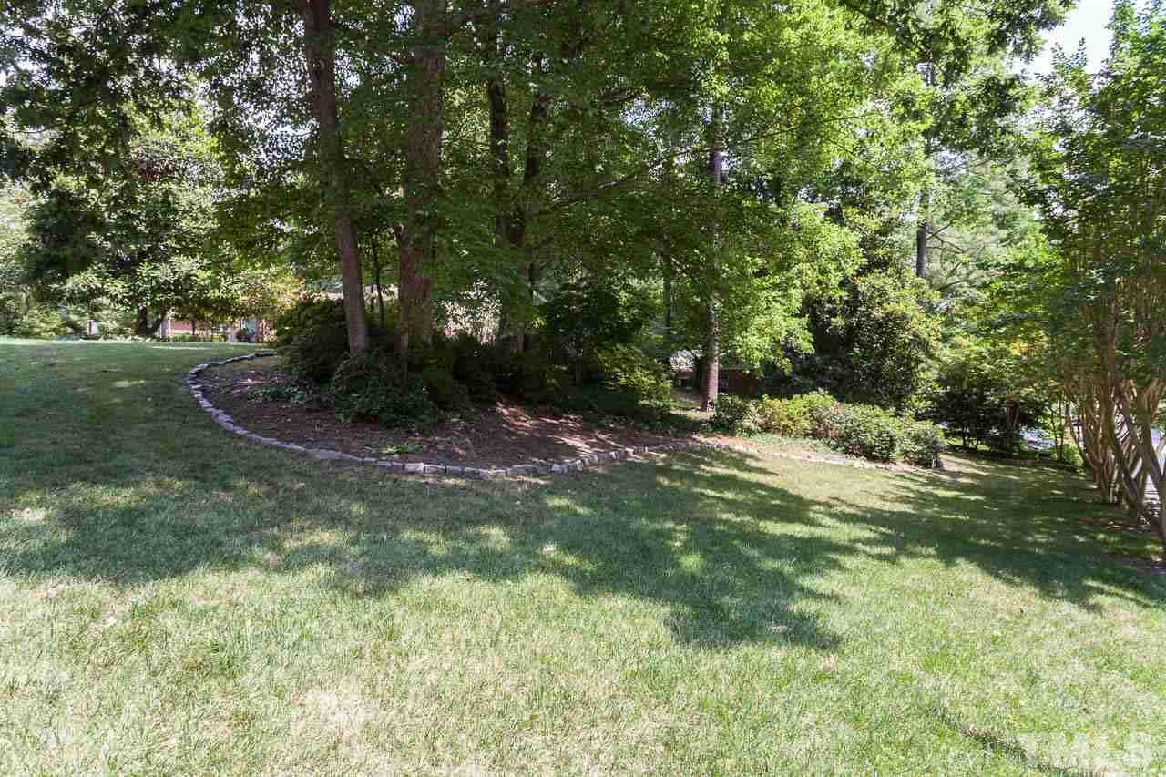 612 Purdue Street Raleigh, NC 27609 - Photo 22 of 25 a backyard of a house with lots of green space