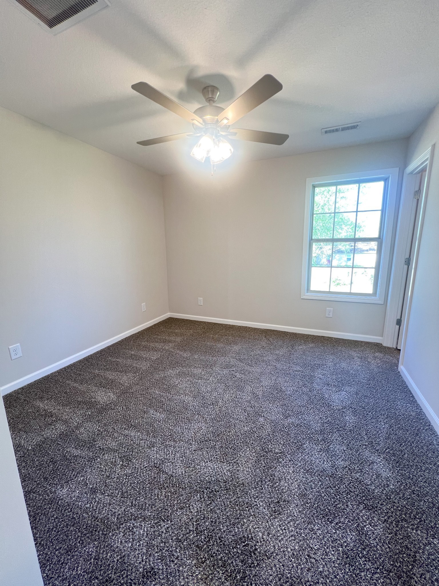 1130 Pembroke Oak Grove Road, Unit 4 Oak Grove, KY 42262 - Photo 18 of 37 en empty room with windows and ceiling fan