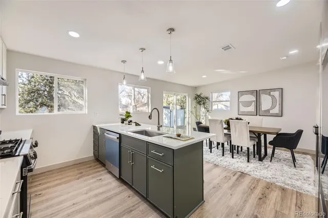 a view of a kitchen counter top space with furniture wooden floor and stainless steel appliances