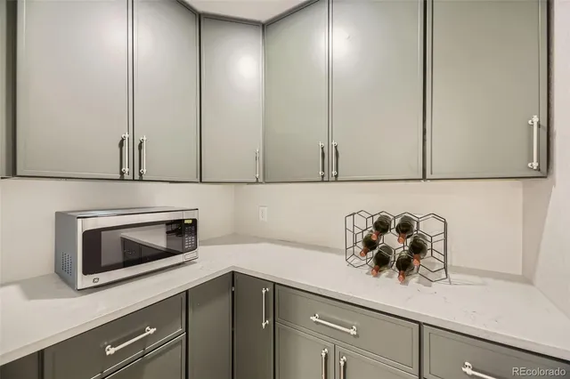 a kitchen with appliances cabinets and a potted plant