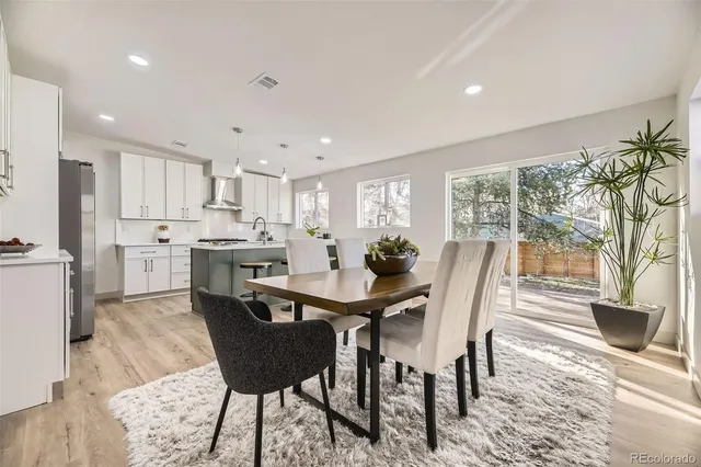 a view of a dining room with furniture and a large window