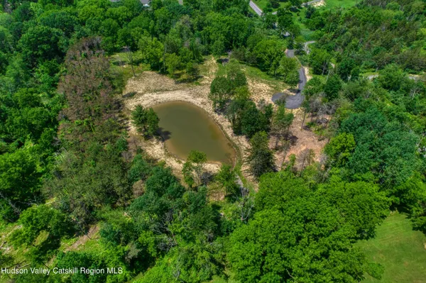 a aerial view of a house with a yard and large trees
