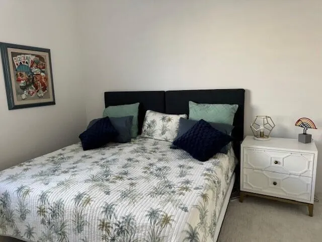 a large bed sitting in a bedroom and dresser