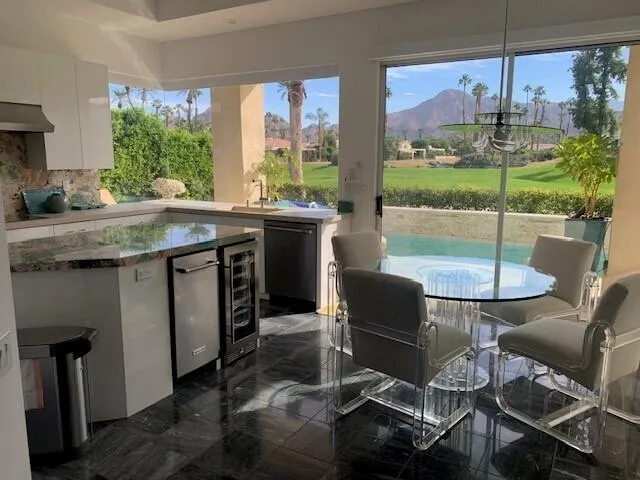 a kitchen with a table chairs stove and wooden floor