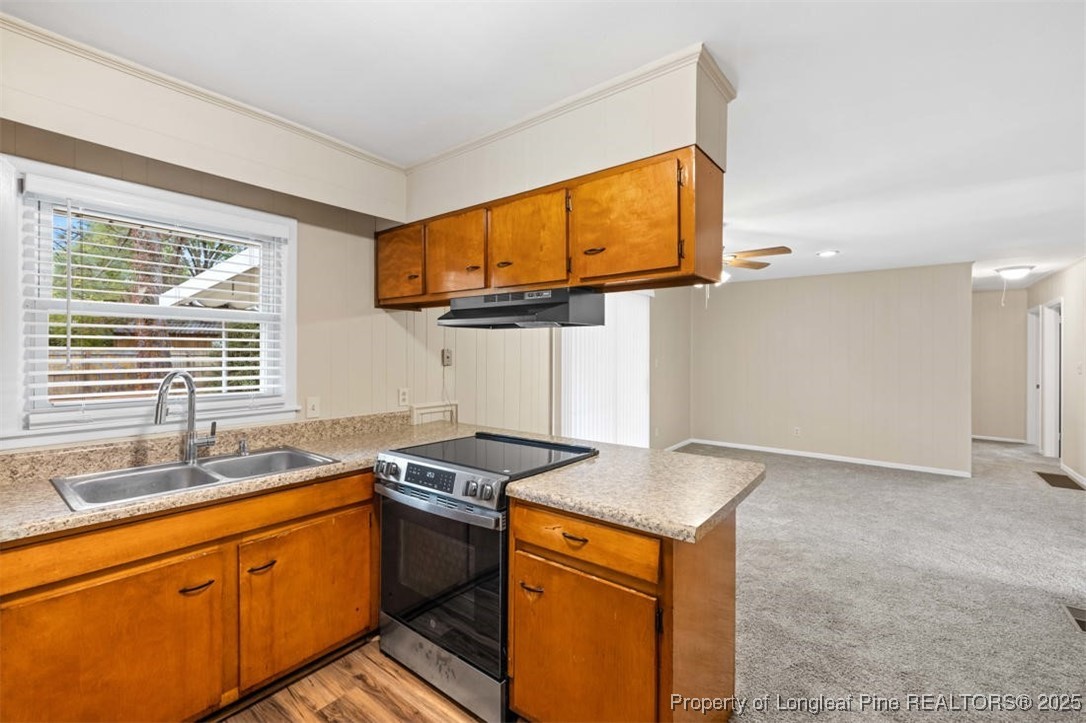 3918 Glenridge Road Fayetteville, NC 28304 - Photo 12 of 31 a kitchen with stainless steel appliances granite countertop a sink stove and cabinets