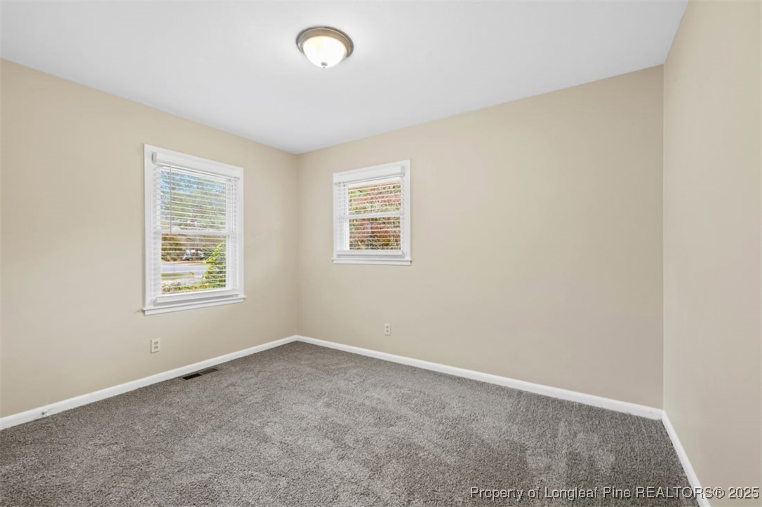 3918 Glenridge Road Fayetteville, NC 28304 - Photo 15 of 31 an empty room with windows