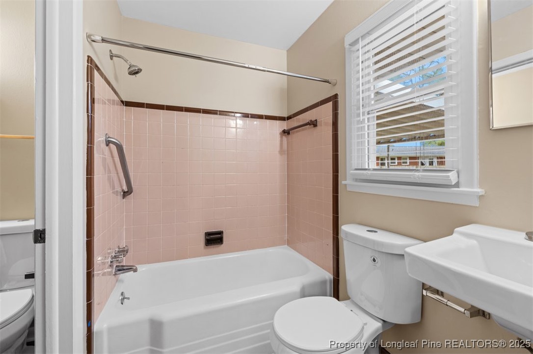 3918 Glenridge Road Fayetteville, NC 28304 - Photo 18 of 31 a bathroom with a toilet and a shower