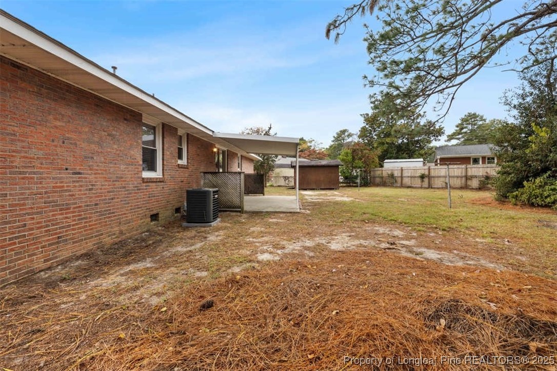3918 Glenridge Road Fayetteville, NC 28304 - Photo 29 of 31 a backyard of a house with barbeque oven and yard