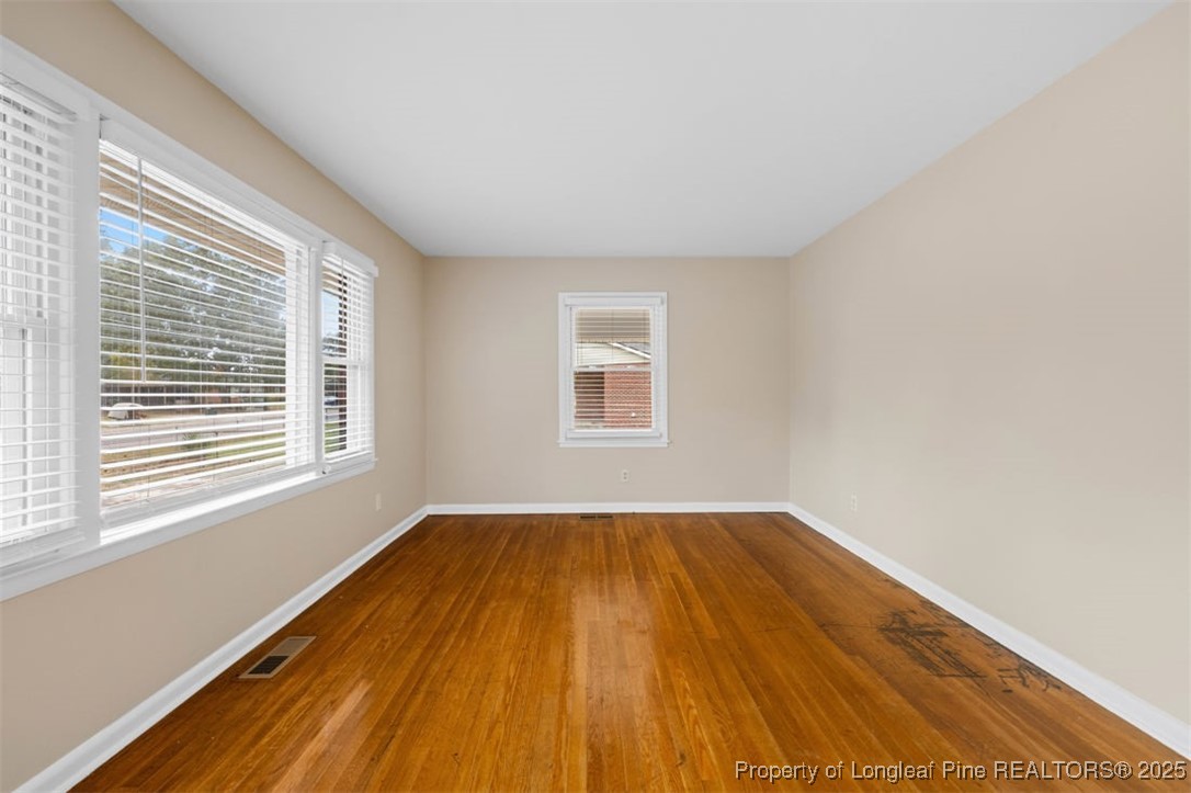 3918 Glenridge Road Fayetteville, NC 28304 - Photo 7 of 31 a view of an empty room with wooden floor and a window