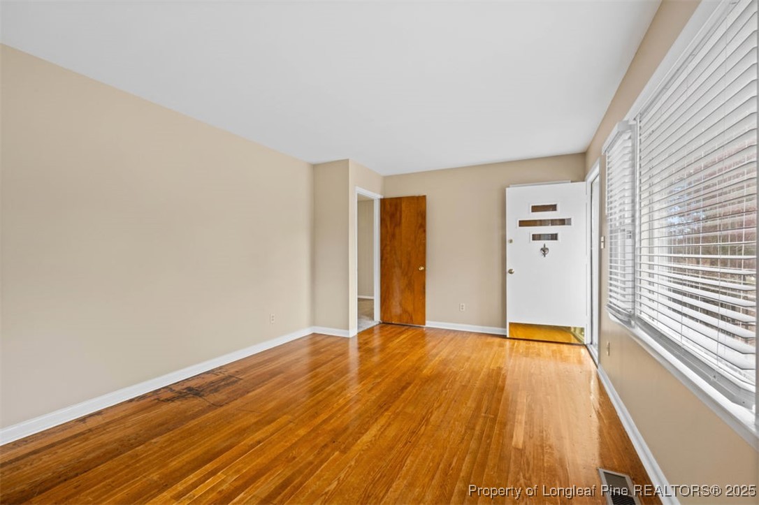 3918 Glenridge Road Fayetteville, NC 28304 - Photo 8 of 31 a view of an empty room with wooden floor
