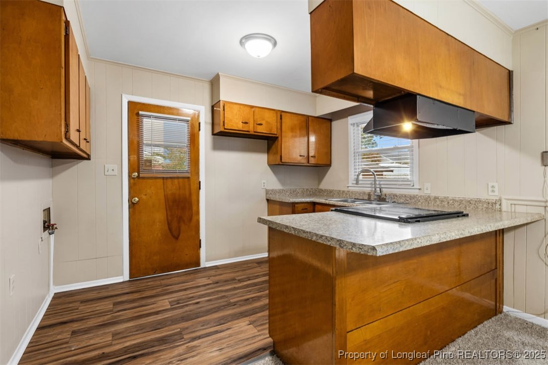 3918 Glenridge Road Fayetteville, NC 28304 - Photo 10 of 31 a kitchen with stainless steel appliances granite countertop a sink a stove and a wooden floors