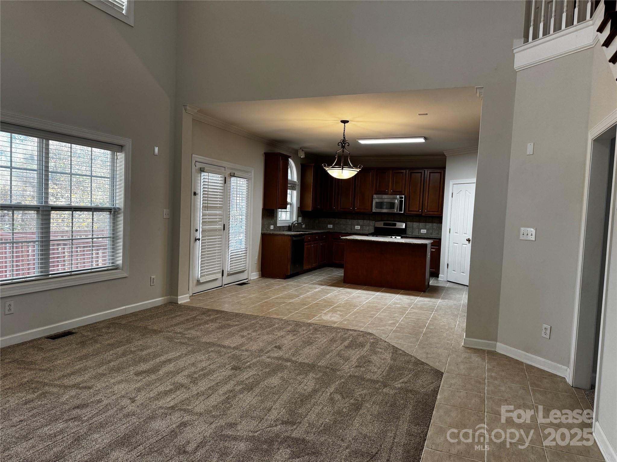 15628 Sullivan Ridge Drive Charlotte, NC 28277 - Photo 12 of 29 a large room with chandelier and wooden floor