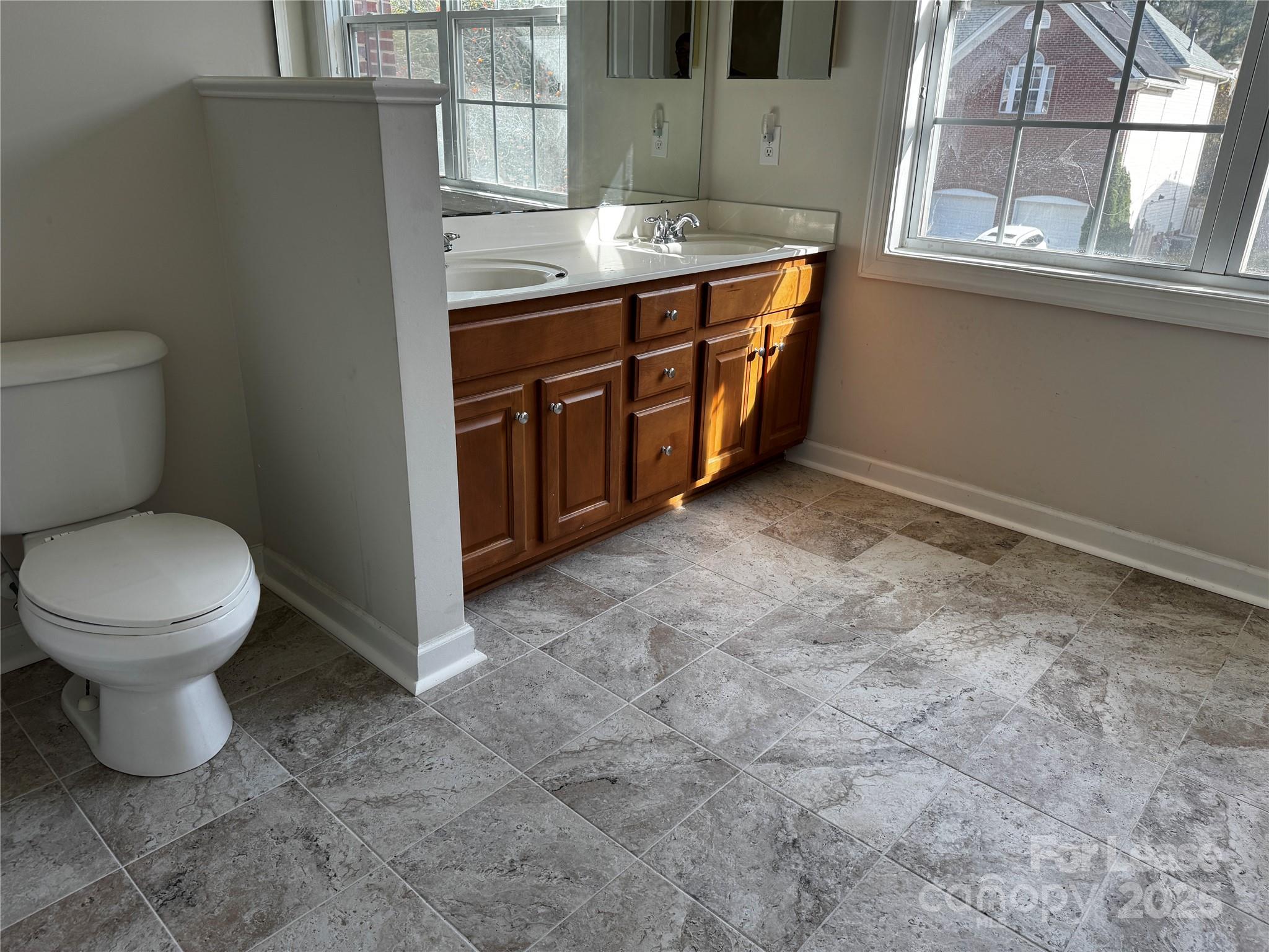 15628 Sullivan Ridge Drive Charlotte, NC 28277 - Photo 25 of 29 a bathroom with a granite countertop toilet and a sink