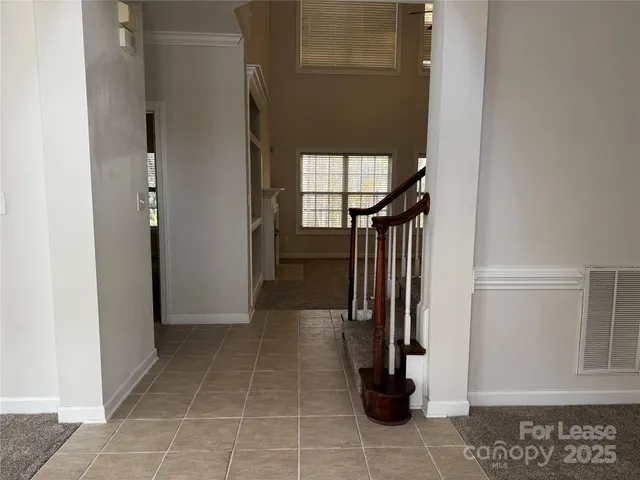 a view of entryway and gallery with wooden floor