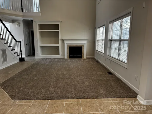 a view of an entryway with wooden floor and livingroom view