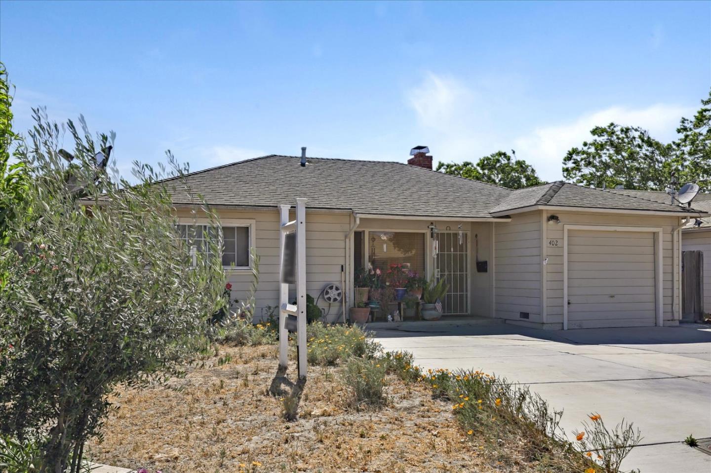 402 Haven Drive King City, CA 93930 - Photo 4 of 22 a front view of a house with a yard and garage
