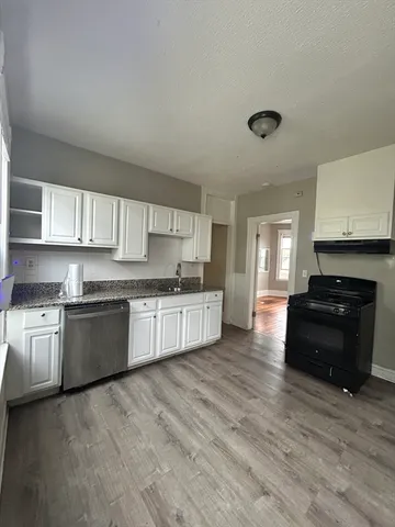 a kitchen with stainless steel appliances granite countertop a stove and a sink