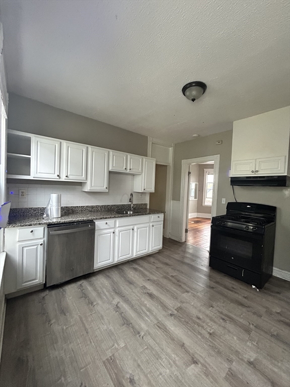205 Hamilton Street, Unit 3 Boston, MA 02122 - Photo 2 of 9 a kitchen with stainless steel appliances granite countertop a stove and a sink
