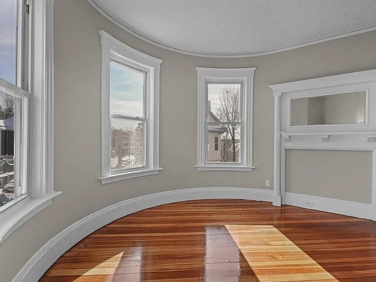 205 Hamilton Street, Unit 3 Boston, MA 02122 - Photo 4 of 9 a view of a livingroom with wooden floor and a window