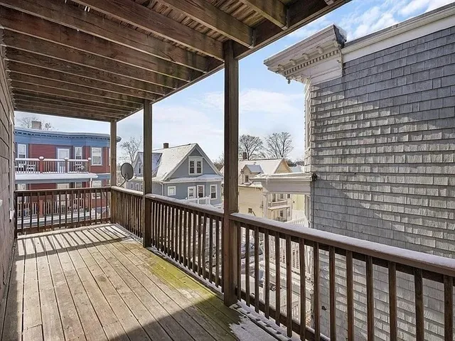 a view of a balcony with wooden floor