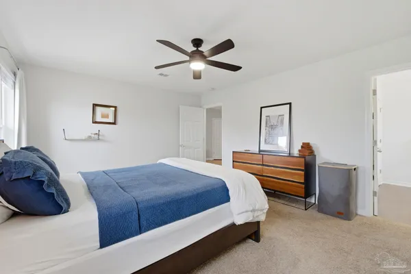 a bed room with a bed and a chandelier