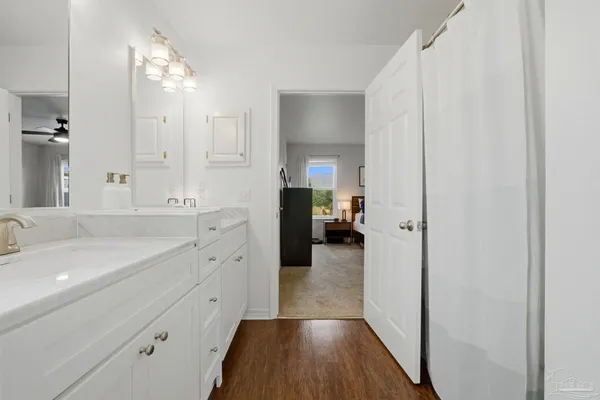 a spacious bathroom with a double vanity sink and mirror