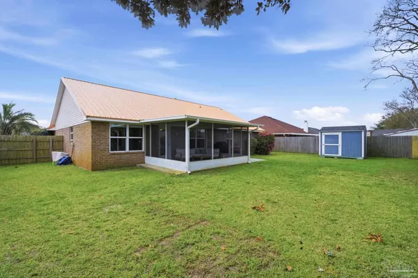 a view of a house with a backyard