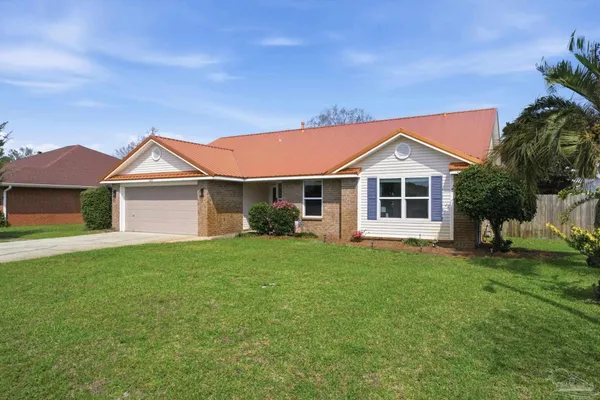 a front view of a house with a garden
