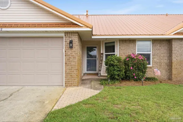 a front view of a house with garden