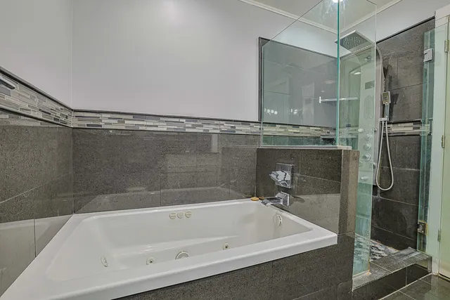 a bathroom with a bathtub and a shower