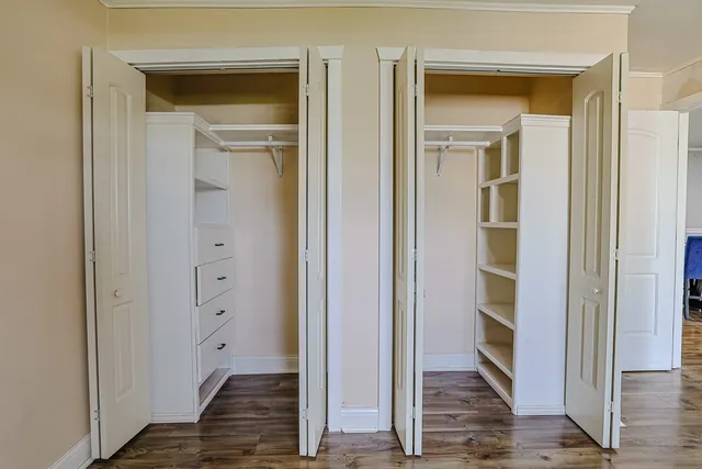 a view of an empty room with wooden floor