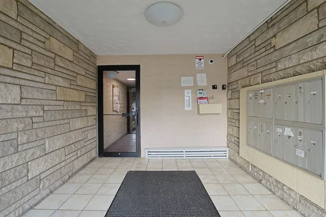 a kitchen with stainless steel appliances granite countertop refrigerator a sink dishwasher a stove top oven a refrigerator with wooden cabinets and floor