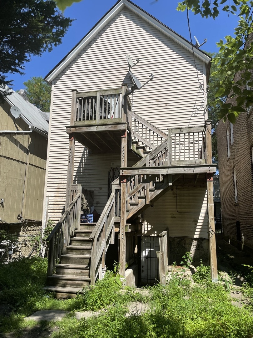 6026 South May Street Chicago, IL 60621 - Photo 2 of 2 a view of a house with wooden stairs and stairs