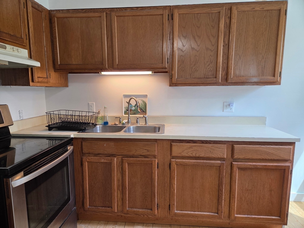 920 Worcester Road Barre, MA 01005 - Photo 21 of 40 a kitchen with granite countertop wood cabinets and stainless steel appliances