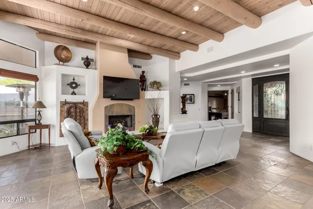 a living room with furniture a fireplace and a flat screen tv