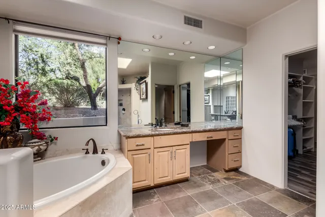 a kitchen with stainless steel appliances granite countertop a table and chairs in it