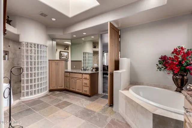 a kitchen with kitchen island granite countertop a table chairs sink and cabinets