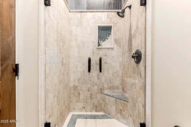 a living room with furniture floor to ceiling window and a floor to ceiling window