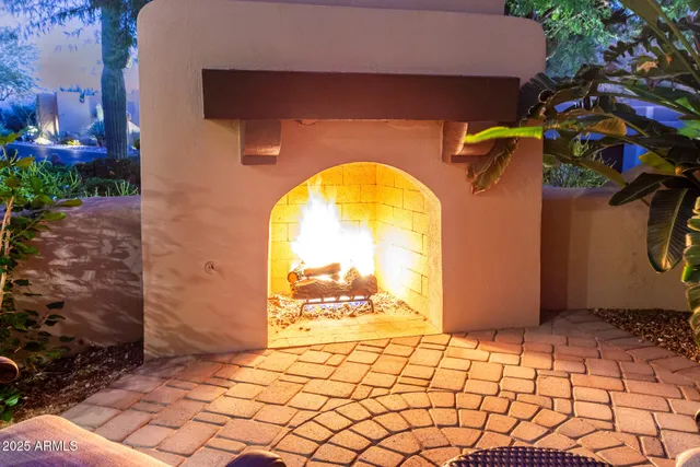 a view of a patio with table and chairs potted plants