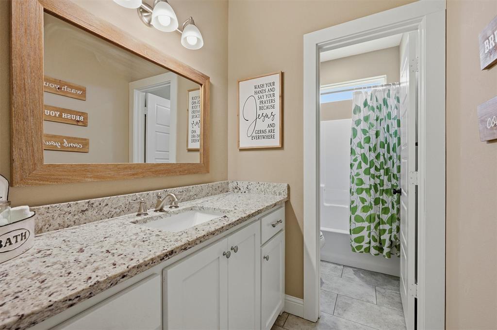 662 Preakness Place Road Van Alstyne, TX 75495 - Photo 23 of 39 a bathroom with a granite countertop sink and a mirror