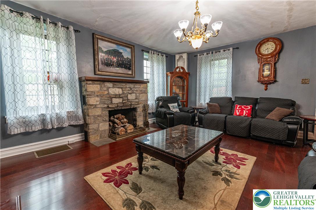 2485 Hieter Road Quakertown, PA 18951 - Photo 21 of 97 A striking stone fireplace anchors this warm living area with polished hardwood floors.