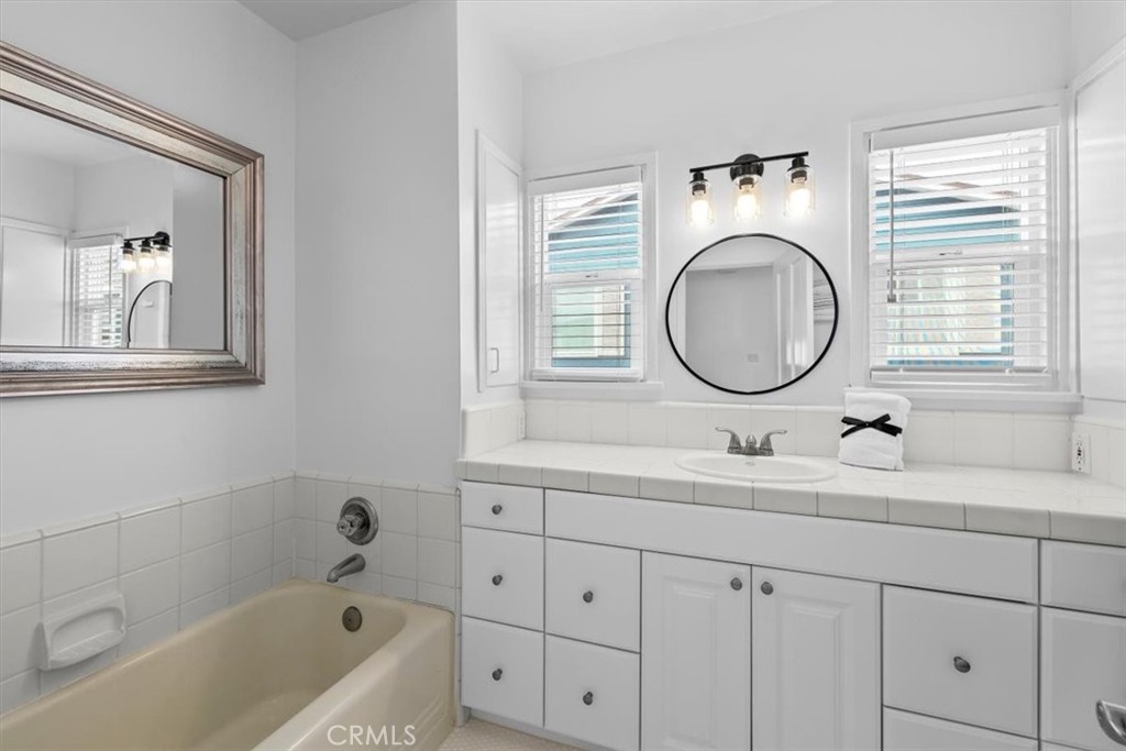 2000 The Strand Manhattan Beach, CA 90266 - Photo 27 of 57 a bathroom with a sink and a mirror with bathtub