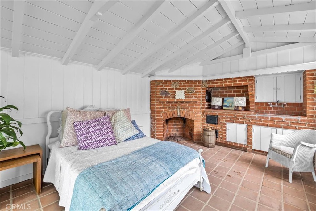 2000 The Strand Manhattan Beach, CA 90266 - Photo 34 of 57 a bedroom with a large bed and a fireplace