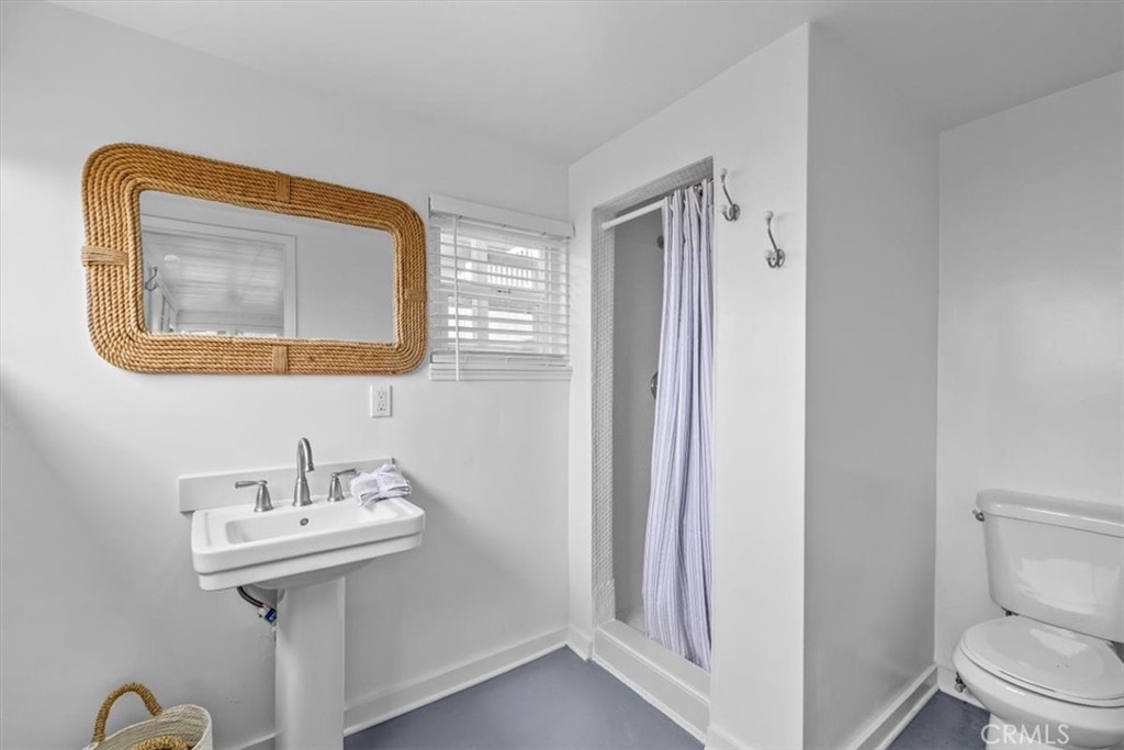 2000 The Strand Manhattan Beach, CA 90266 - Photo 43 of 57 a bathroom with a sink mirror and toilet
