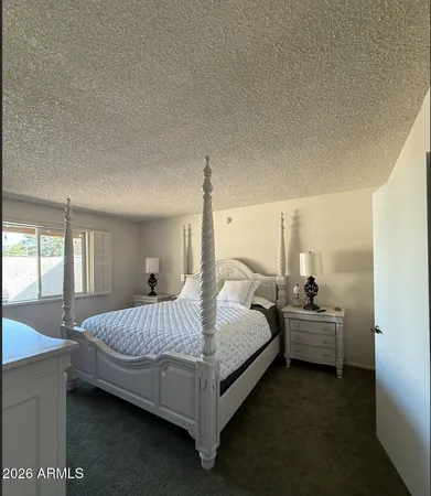 a bedroom with a bed and window