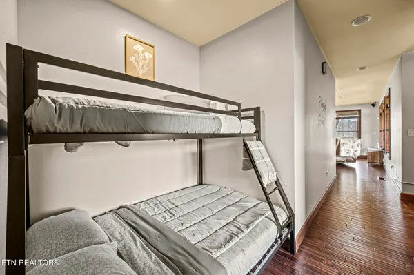 a bedroom with furniture and a flat screen tv