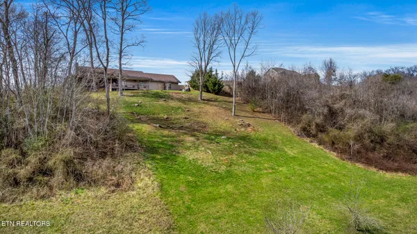 an aerial view of a house with a lake view