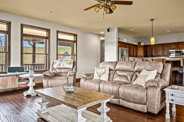 a dining room with furniture a rug and wooden floor