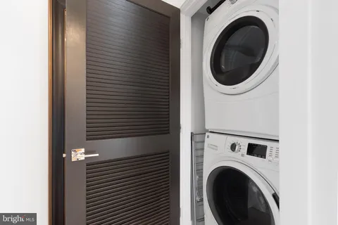 a view of a hallway with washer and dryer